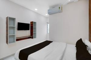 Postel nebo postele na pokoji v ubytování Hotel O RB Delight