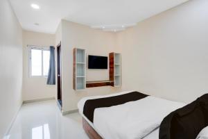 A bed or beds in a room at Hotel O RB Delight