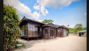 a house with a lot of windows on it at Lucia Seaside Villa Amami in Wada
