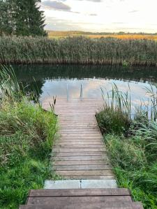 a wooden bridge over a body of water at Lauga Puhkemaja in Tammeveski