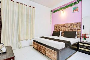 Un dormitorio con una cama grande en una habitación. en Hotel O Adarsh Nagar Metro Station Delhi Formerly Family Inn, en Nueva Delhi