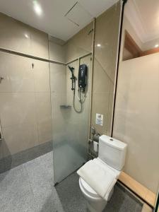 a bathroom with a toilet and a shower stall at iBilik Hotel - Sunway Lagoon, Petaling Jaya in Petaling Jaya +10 photos