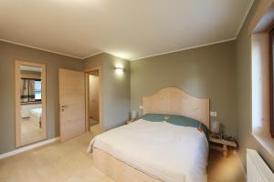 Postel nebo postele na pokoji v ubytování Zoncolan Apartments