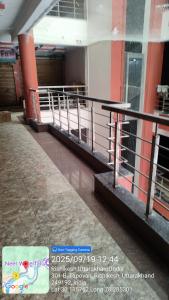 an empty hallway of a building with a fence at Hotel Nirwan in Rishīkesh