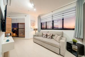 a living room with a couch and some windows at D Top View in St. Paul's Bay