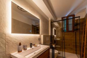 a bathroom with a white sink and a shower at Ina's Lake Garden Nicolas Suite in Lenno +29 photos