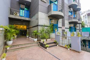 a building with a bunch of plants in front of it at Nikko Blue - Boutique Hotel in Gurgaon