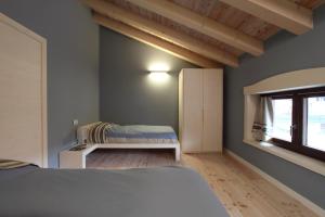Postel nebo postele na pokoji v ubytování Zoncolan Apartments