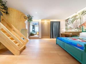 a bedroom with a bunk bed and a desk at Bliss International Hotel Weihai in Weihai