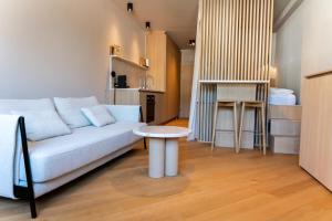 a living room with a couch and a table at Design Apartment Bad Aussee in Bad Aussee