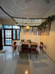 a dining room with a table and chairs at CASA BOHEMIAn in Rishīkesh +74 photos