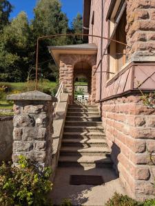 a stone stairway to a building with an entrance at La Maison de Marie in Les Rouges-Eaux