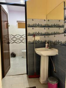 a bathroom with a sink and a toilet at CASA BOHEMIAn in Rishīkesh