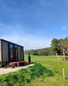 a tiny house sitting on a table in a field at Perrys South by Tiny Away in Forth