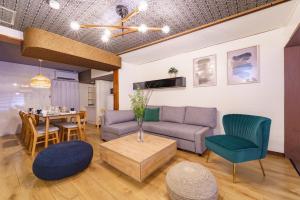 a living room with a couch and chairs and a table at 3minNagoya 13ppl 36minCentrair 3BR 30min LEGOLAND in Nagoya