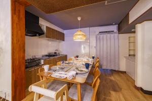 a dining room with a table and chairs in a kitchen at 3minNagoya 13ppl 36minCentrair 3BR 30min LEGOLAND in Nagoya