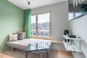a living room with a couch and a window at Lifestylehotel Das Max in Seefeld in Tirol +69 photos