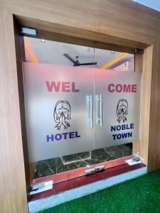 a welcome door to a hotel with a welcome sign at Hotel Noble Town in Gandhinagar