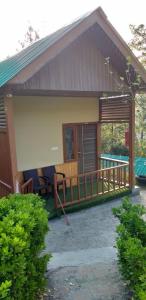 a small house with a porch and a balcony at Paradise Village Resort in Shimla