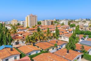 a city with houses and palm trees and buildings at TWO BEDROOM APARTMENT BAMBURI Mombasa in Mombasa