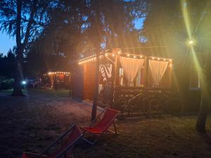 a tiny house with lights on it at night at Domki u Ani in Okuninka