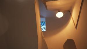 Un pasillo con una luz en la pared y una lámpara. en CityLife Lahore Boutique Heritage Home In Walled City, en Lahore