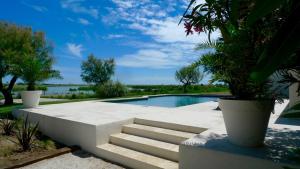 a swimming pool with stairs next to at Mas des Cabidoules in Saintes-Maries-de-la-Mer