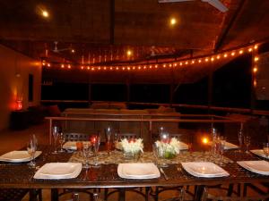 a table in a room with lights and lights at Manoas in Uvita