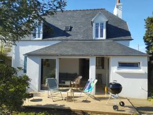 a house with chairs and a grill on a deck at Jolie maison de familial au cœur de Carantec - TY LAOUEN in Carantec +29 photos