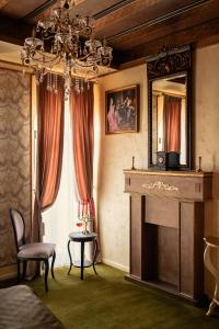 a living room with a fireplace and a mirror at Belle Epoque Boutique (Adult Only) in Constanţa