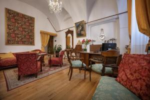 a living room with a couch and a table and chairs at Little King Hotel U Malvaze in Prague