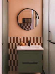 a bathroom with a sink and a mirror at Saint J Hotel by Brassbell in Cairo