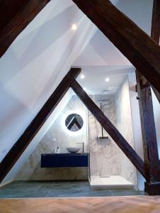 a attic bathroom with a sink and a mirror at Lemullier de Bressey - Hôtel particulier au coeur de Dijon in Dijon +58 photos