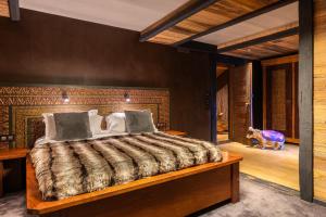 a bedroom with a bed and a dog in a room at Black Diamond - Chalet Ubud in Les Brévières +36 photos