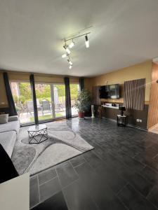 a living room with a couch and a tv at Ferienwohnung "Im Herzen des Westerwalds" in Ettinghausen