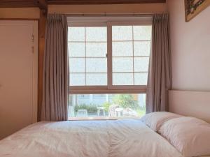 a bedroom with a bed and a large window at 'Hanok Hanok' Boutique stay Hotel Seoul - 2min from Gyeongbokgung Palace station in Seoul