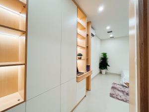 a hallway with wooden shelves and a closet at Soin Riverside Apartment in Hanoi +76 photos