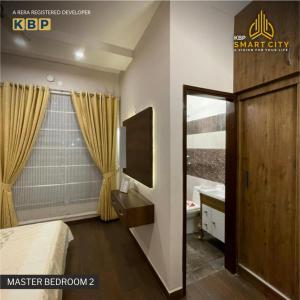 a bedroom with a bed and a tv and a mirror at Kbp Smart City in Kharar