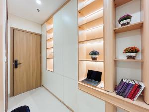 a room with a door and a laptop on a shelf at Soin Riverside Apartment in Hanoi