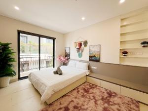 a bedroom with a large bed and a window at Soin Riverside Apartment in Hanoi