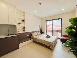 a bedroom with a bed and a sink and a window at Soin Riverside Apartment in Hanoi