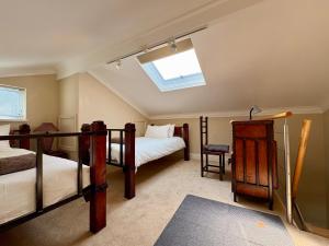 a bedroom with two bunk beds and a skylight at Spinnaker Quays Waterfront Villa in Knysna