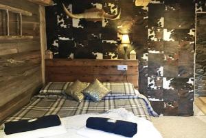 a bed room with a bed and a painting on the wall at Chalet Eterlou in Tignes