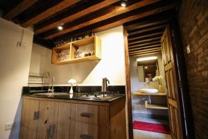 a kitchen with a sink and a stove in it at Balcony apartment- 50m from Patan Durbar Sq in Pātan +23 photos