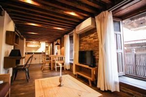 a living room with a table and a tv and a window at Balcony apartment- 50m from Patan Durbar Sq in Pātan