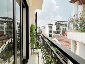 a balcony with plants and a view of buildings at Soin Riverside Apartment in Hanoi