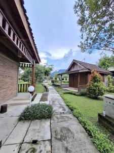 a house with a pathway next to a building at Balkondes Tuksongo in Borobudur
