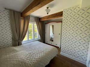 a bedroom with a bed and a window at 2 room apartment in Sikana Manor 