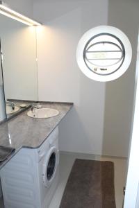 uma casa de banho com uma máquina de lavar roupa e um lavatório em OPO.APT - Art Deco Apartments in Oporto's Center no Porto