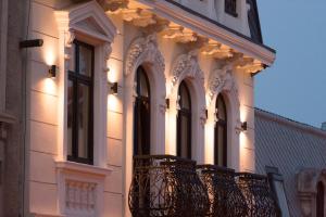 a building with a balcony with lights on it at Belle Epoque Boutique (Adult Only) in Constanţa +120 photos